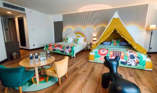 a bedroom with a bed and a table and a bed with a tent at Premiere Hotel - Complimentary Shuttle to Klang Wholesale Market in Klang