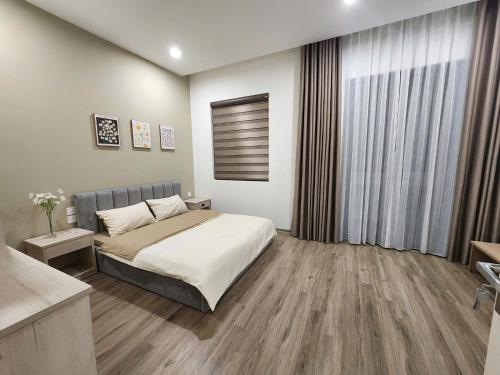 Postel nebo postele na pokoji v ubytování SH14-55, Vinhome Ocean Park 2