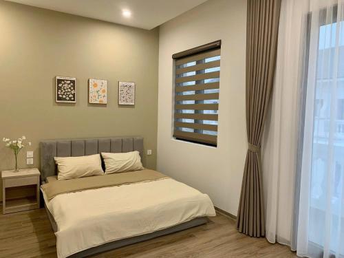 Postel nebo postele na pokoji v ubytování SH14-55, Vinhome Ocean Park 2