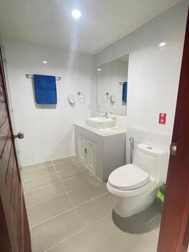 a bathroom with a white toilet and a sink at The Sun Pool Villa in Chaweng