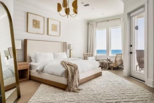a bedroom with a large bed and a mirror at Miramare - Beachfront Luxury with Pool & Elevator in Orange Beach