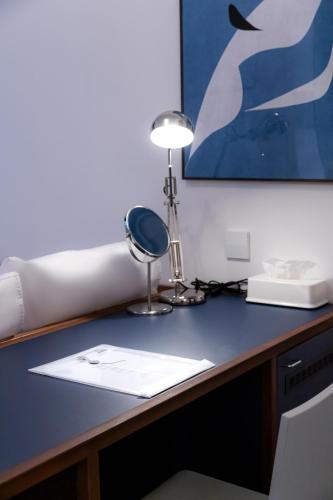 a desk with a lamp on top of it at Small House Big Door Myeongdong in Seoul