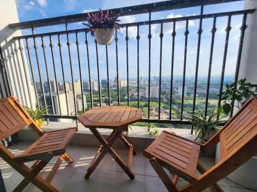 a table and chairs on a balcony with a view at GreenBay- G34030 in Hanoi