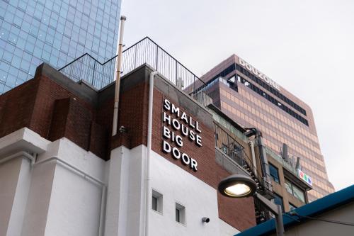 a building with a sign on the side of it at Small House Big Door Myeongdong in Seoul