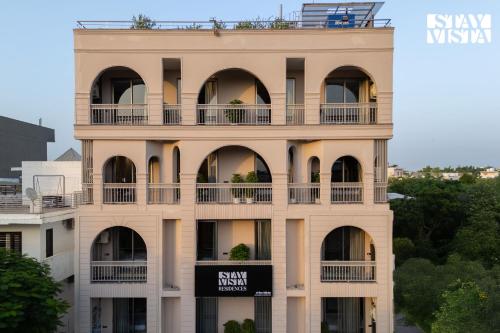 a building with a sign on the side of it at StayVista Residences near Cyber City Hub with Gym & Air Purifier in Gurgaon