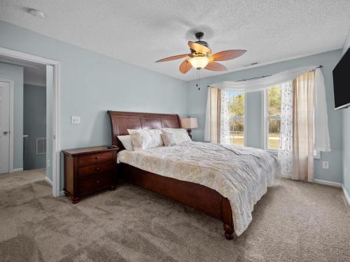 a bedroom with a bed and a ceiling fan at Freedom's Stay at Liberty Hills in Jacksonville