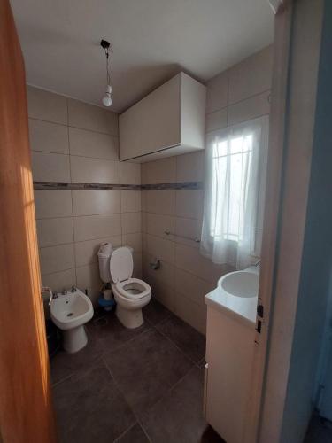 a bathroom with a toilet and a sink at Paz en Funes in Funes