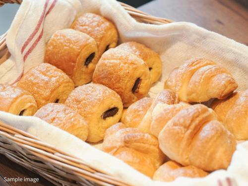 a basket full of pastries sitting on a table at Hotel Brighton City Osaka Kitahama in Osaka