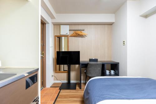 Postel nebo postele na pokoji v ubytování Sleep Inn Gotanda