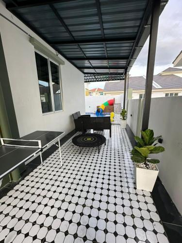 a patio with a table and a couch on a house at Homestay Private Pool in Langgar