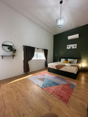 a bedroom with a bed and a rug at Homestay Private Pool in Langgar