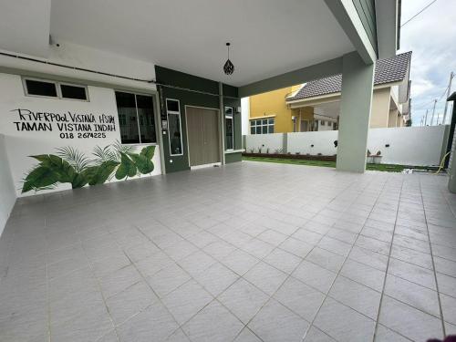 an empty courtyard of a building with a sign on it at Homestay Private Pool in Langgar
