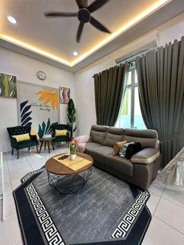 a living room with a couch and a table at Homestay Private Pool in Langgar