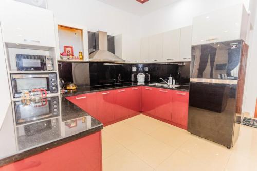 a kitchen with red and white cabinets and appliances at Tiên Hoa Sơn Villa in Da Lat