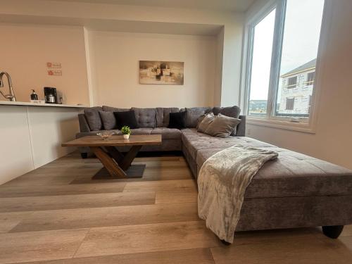 a living room with a couch and a table at Upscale Niagara Falls Getaway - BRAND NEW in Niagara Falls