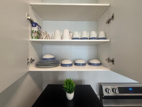 a kitchen with blue and white dishes and a table at Upscale Niagara Falls Getaway - BRAND NEW in Niagara Falls