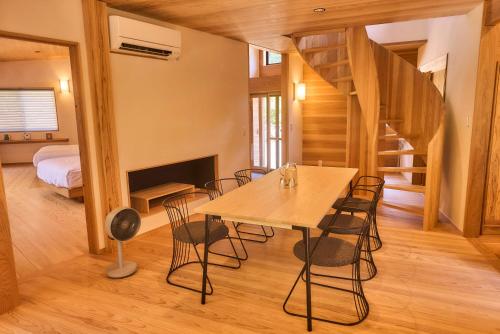 a dining room with a table and chairs at 日照雨 SOBAE Stream Villa YAKUSHIMA Private villa on the river in the primeval forest in Yudomari