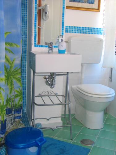 a bathroom with a white sink and a toilet at L'isola di Gaia in Crotone