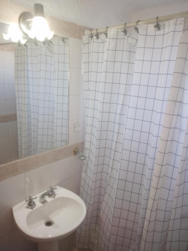 a bathroom with a sink and a shower curtain at Todo cerca en la ciudad in Buenos Aires