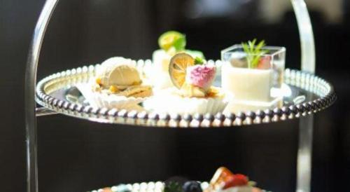 a plate of food on a tray with a drink at Tongxiang Inspirock Hotel in Jiaxing