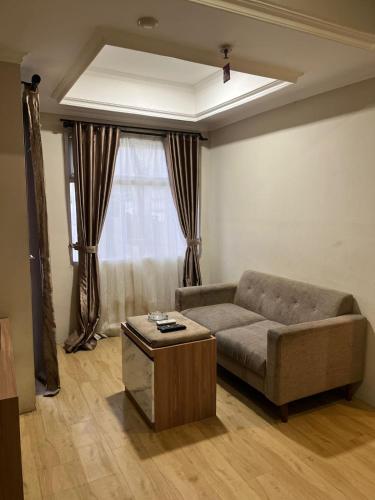 a living room with a couch and a table at instaspace in Bandung