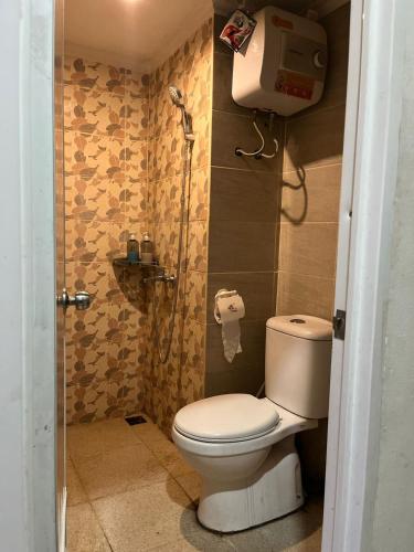 a bathroom with a toilet and a shower at instaspace in Bandung