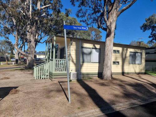 a blue street sign in front of a house at Eagle Point Caravan Park in Eagle Point