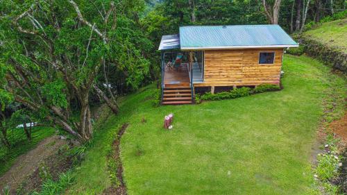an aerial view of a small wooden cabin on a hill at Monte y Alma Monteverde in Cebadilla
