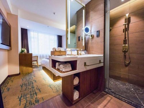 a bathroom with a sink and a shower at James Joyce Coffetel Changchun People's Square in Changchun