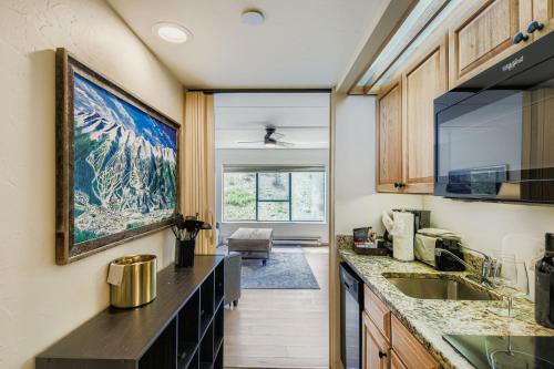 a kitchen with a large painting on the wall at Ski In Ski Out Dog Friendly Studio Building 4 in Breckenridge