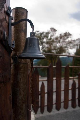 a bell is attached to a wooden fence at Gorosarri in Escoriaza