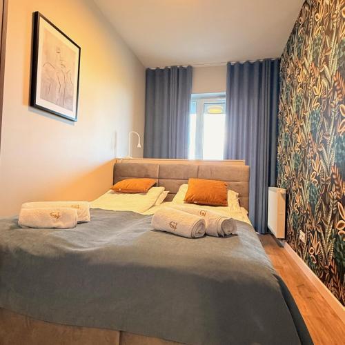 a bedroom with a bed with two pillows on it at Apartament GJ PLAZA in Kielce