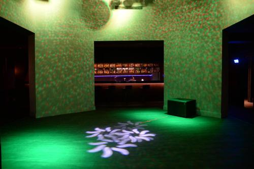 a dark room with a purple flower projected on the floor at Le Bleu Hotel & Resort Kusadasi in Kusadası