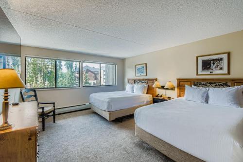 a hotel room with two beds and a window at 2 Bedroom Beaver Run Condo, Ski-in Ski-out, Dog Friendly, On Peak 9 in Breckenridge
