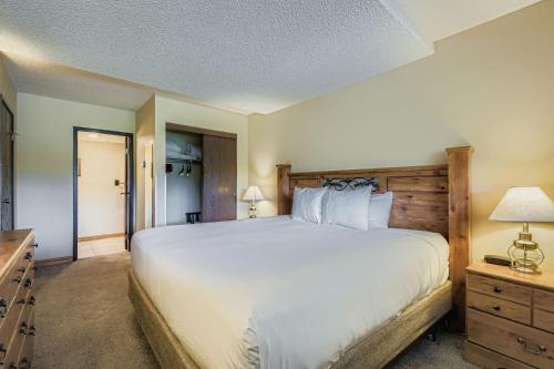 a bedroom with a large bed with a wooden headboard at 2 Bedroom Beaver Run Condo, Ski-in Ski-out, Dog Friendly, On Peak 9 in Breckenridge