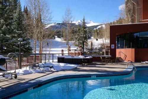 a swimming pool in the snow next to a building at 2 Bedroom Beaver Run Condo, Ski-in Ski-out, Dog Friendly, On Peak 9 in Breckenridge