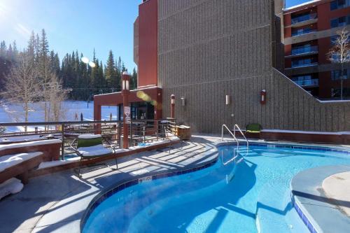 a large swimming pool in front of a building at 2 Bedroom Beaver Run Condo, Ski-in Ski-out, Dog Friendly, On Peak 9 in Breckenridge