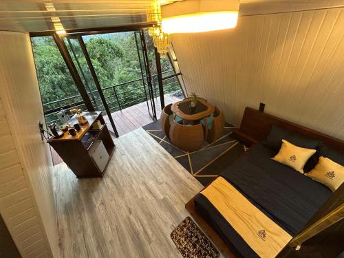 a bedroom with a bed and a balcony at Cabin Alpha in Bandarawela