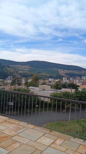 a view of a city from a balcony with a road at Casa com piscina para até 6 pessoas com duas camas de casal e sofá-cama casal in Serra Negra