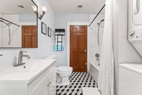 a white bathroom with a black and white tile floor at Bright Coastal Escape 4 Bedroom 2 Bath Near CSULB Long Beach Airport and Beach in Long Beach