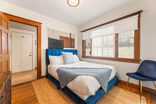 a bedroom with a blue bed and a blue chair at Bright Coastal Escape 4 Bedroom 2 Bath Near CSULB Long Beach Airport and Beach in Long Beach