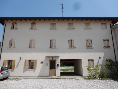 a large white building with a car parked in front at Cà Francine in Gruaro