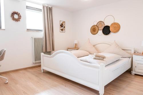 a white bed in a room with a window at Ferienwohnung Alpenglück in Seeg