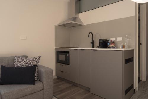 a living room with a couch and a kitchen at 429 Apartments & Suites in Hobart