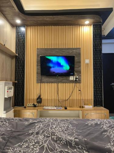 a bedroom with a flat screen tv on a wall at instaspace in Bandung