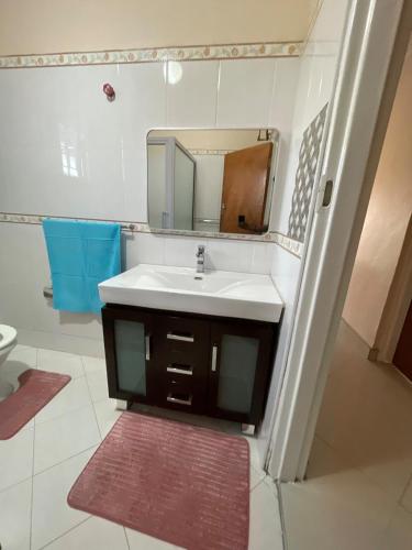 a bathroom with a sink and a mirror at Cozy home in Area 43, Lilongwe in Lilongwe