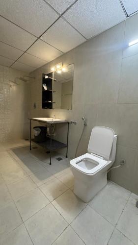a bathroom with a toilet and a sink at Ponneri Gymkhana Club in Ponneri