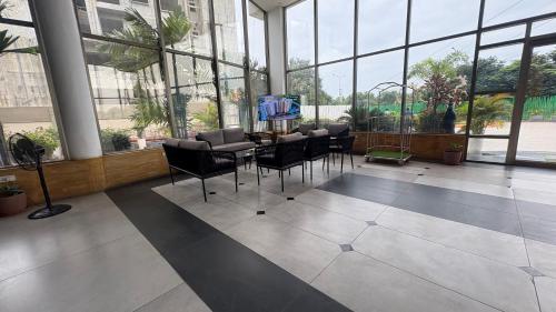 a lobby with a table and chairs in a building at Ponneri Gymkhana Club in Ponneri