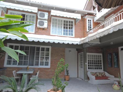 a brick house with a couch on a patio at Pousada Don Alberto's in Florianópolis