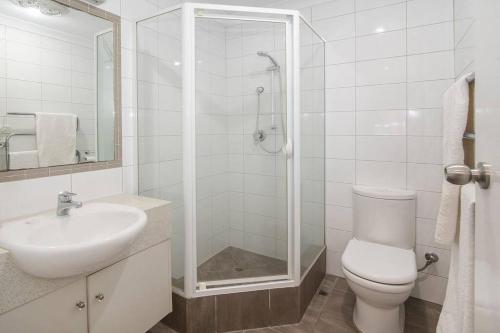 a bathroom with a toilet and a sink and a shower at Jetty Views -100m to foreshore in Busselton
